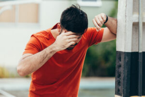 man holding his head in pain